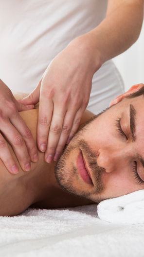 Man receiving a relaxing full-body massage from a therapist