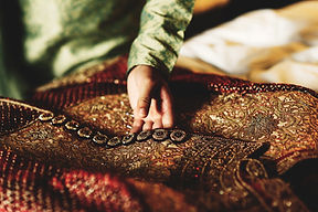 groom-green-shirt-touches-his-red-sherwani.jpg