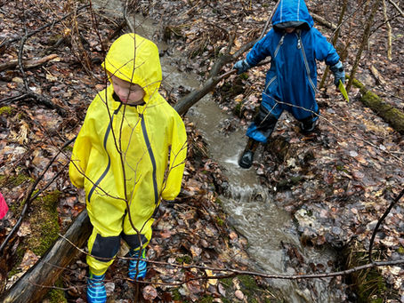 two kids walking in the rain