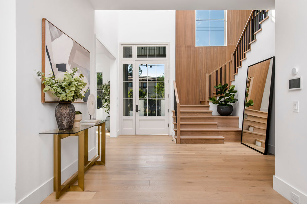 High-end contemporary living room built in Los Angeles with oversized sliding doors, custom lighting, modern sectional seating, and backyard view.