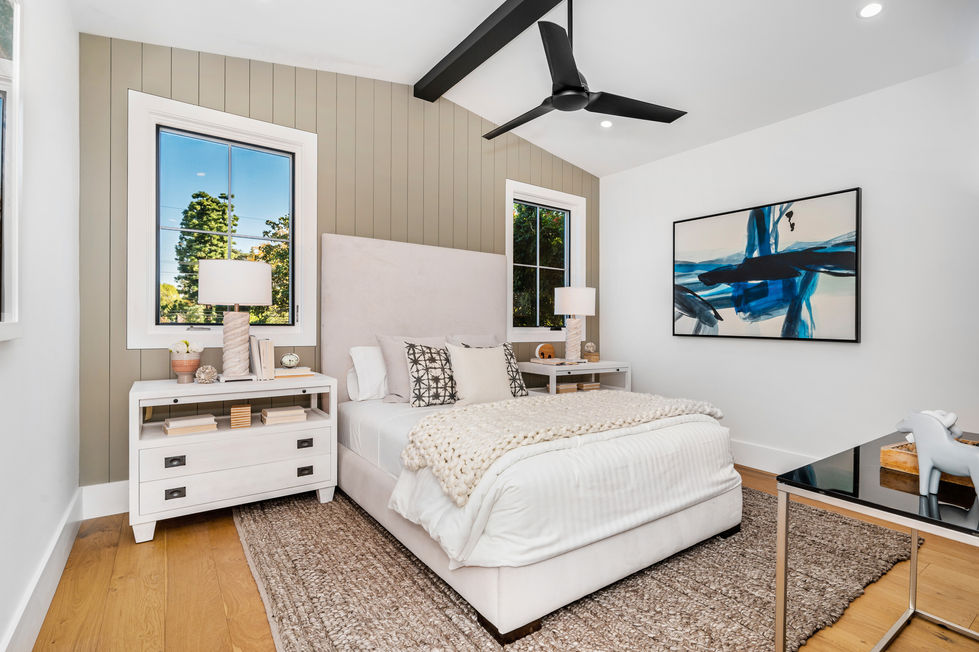 Modern guest bedroom in Los Angeles featuring minimalist design, wide plank hardwood floors, and contemporary finishes.
