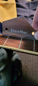 Guitar fretboard with StewMac tool