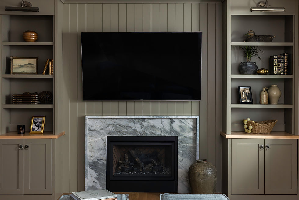 Gray built-in media wall with a marble fireplace and open display shelves