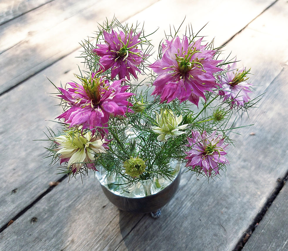 Thumbnail: bunch of mulberry rose nigella flowers in antique flower frog vase