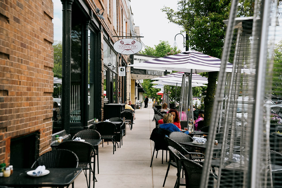 napolita wilmette sign on a sidewalk with striped umbrellas