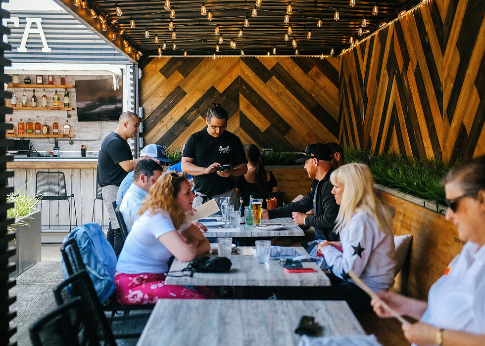 Live music on the patio at Napolita Northbrook with guests enjoying Neapolitan pizza and wine at sunset