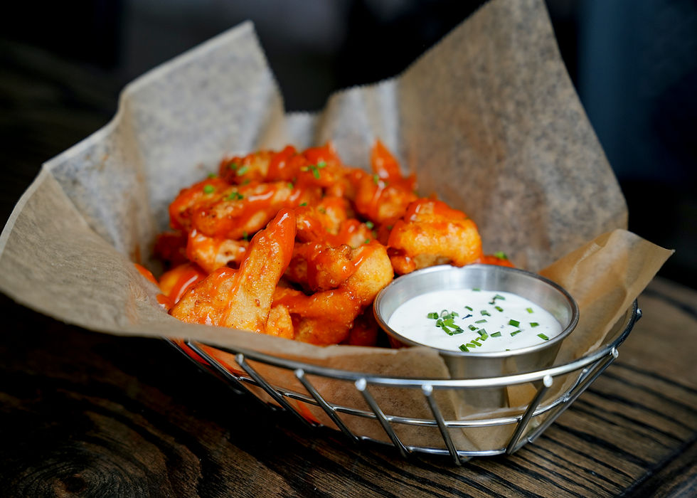 Crispy beer-battered cauliflower wings served with celery, carrots, and ranch dipping sauce at Double Clutch Brewing Company in Evanston