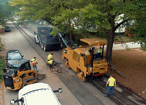 NCEP asphalt milling crew removing pavement along a residential road