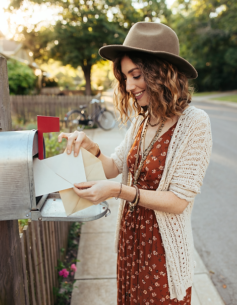 Firefly_a photo of a boho styled woman standing at a letter box, smiling quietly whilst sh