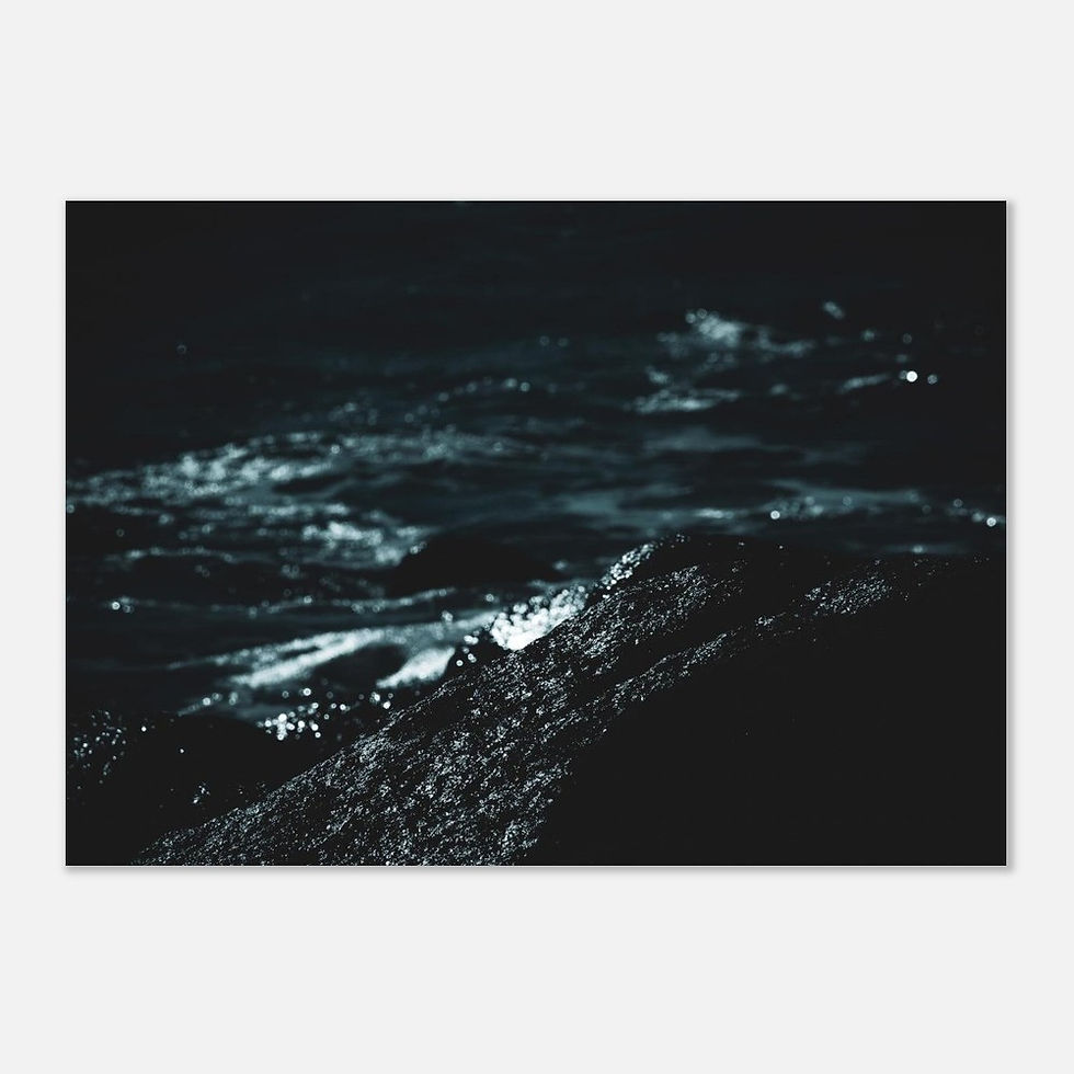 Thumbnail: High-contrast photograph of ocean waves crashing over dark rocks, with bright white foam and droplets illuminated against dee