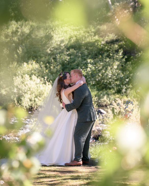 Bride and groom first kiss at Dancing Pines wedding Truckee photographer