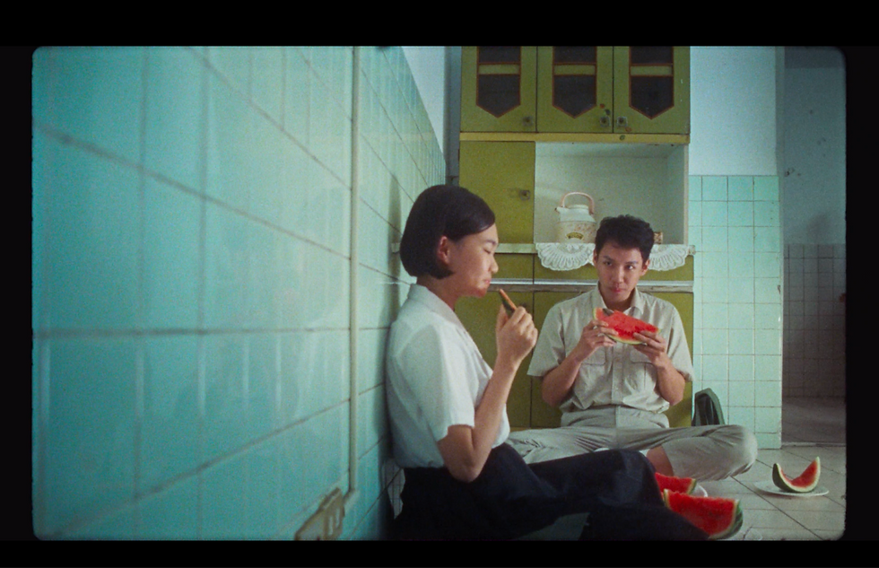Ming and a boy eat watermelons together on a hot summer day in 1980s Taiwan. (Credit: Common State Images)