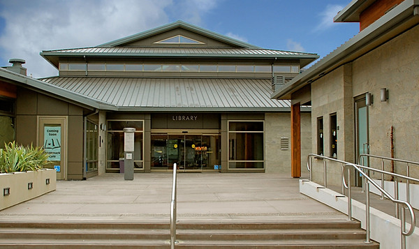 The outside of a building with glass sliding doors and a short staircase