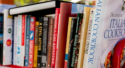 Various different books on a red rolling cart
