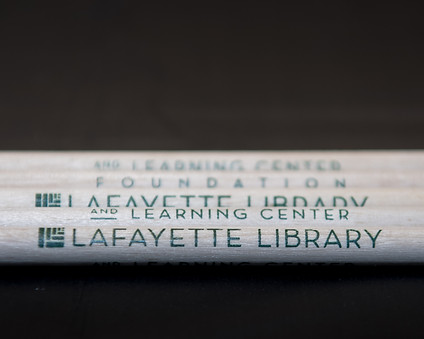 White pencils on a solid black background