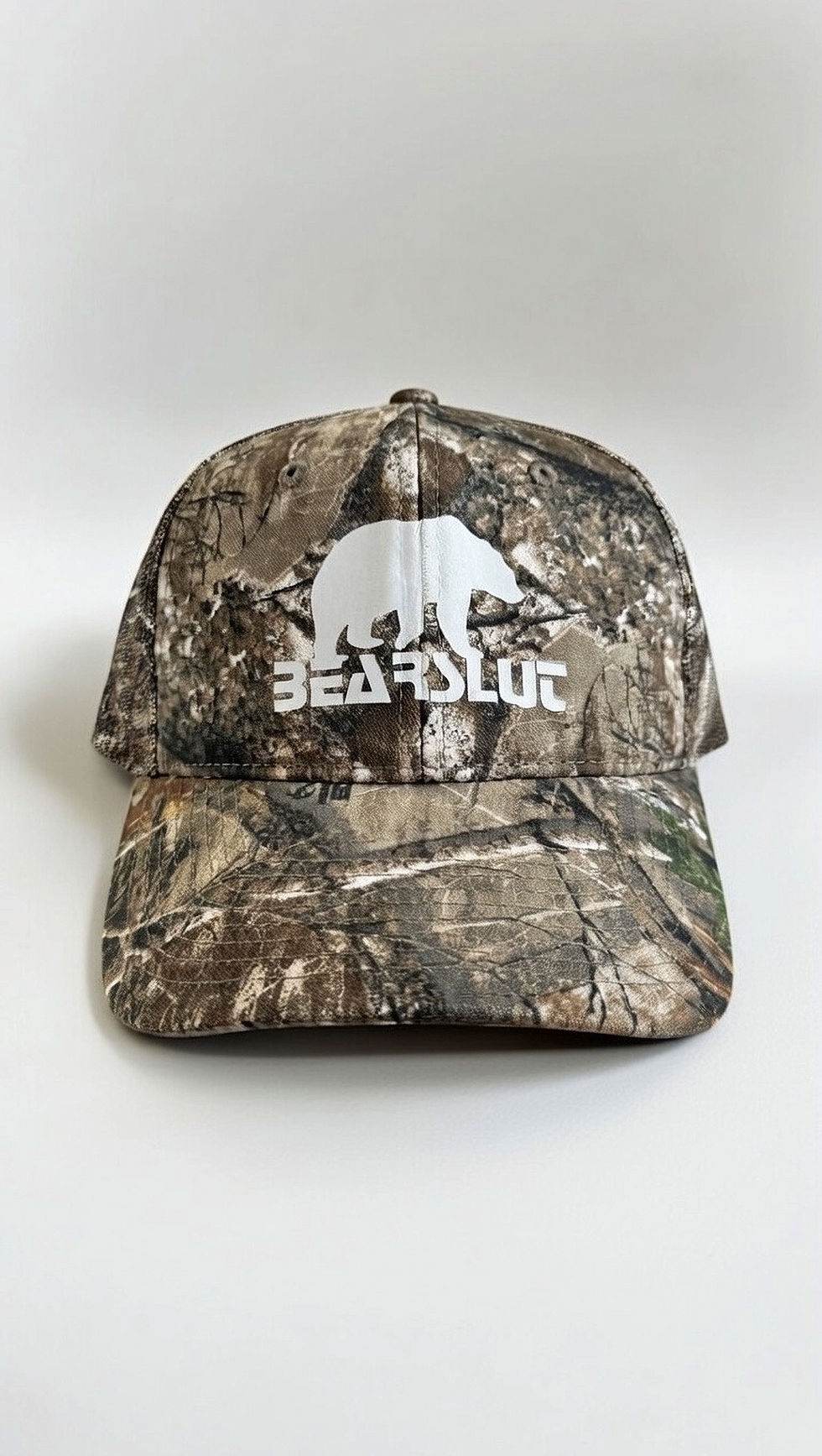 Real Tree camouflage trucker hat with white Bearslut logo on front panel.