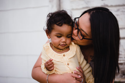 Mom kissing daughter on the cheek