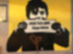 Graffiti of a young boy holding a sign that says 'Open Your Arms: Refugees Welcome'