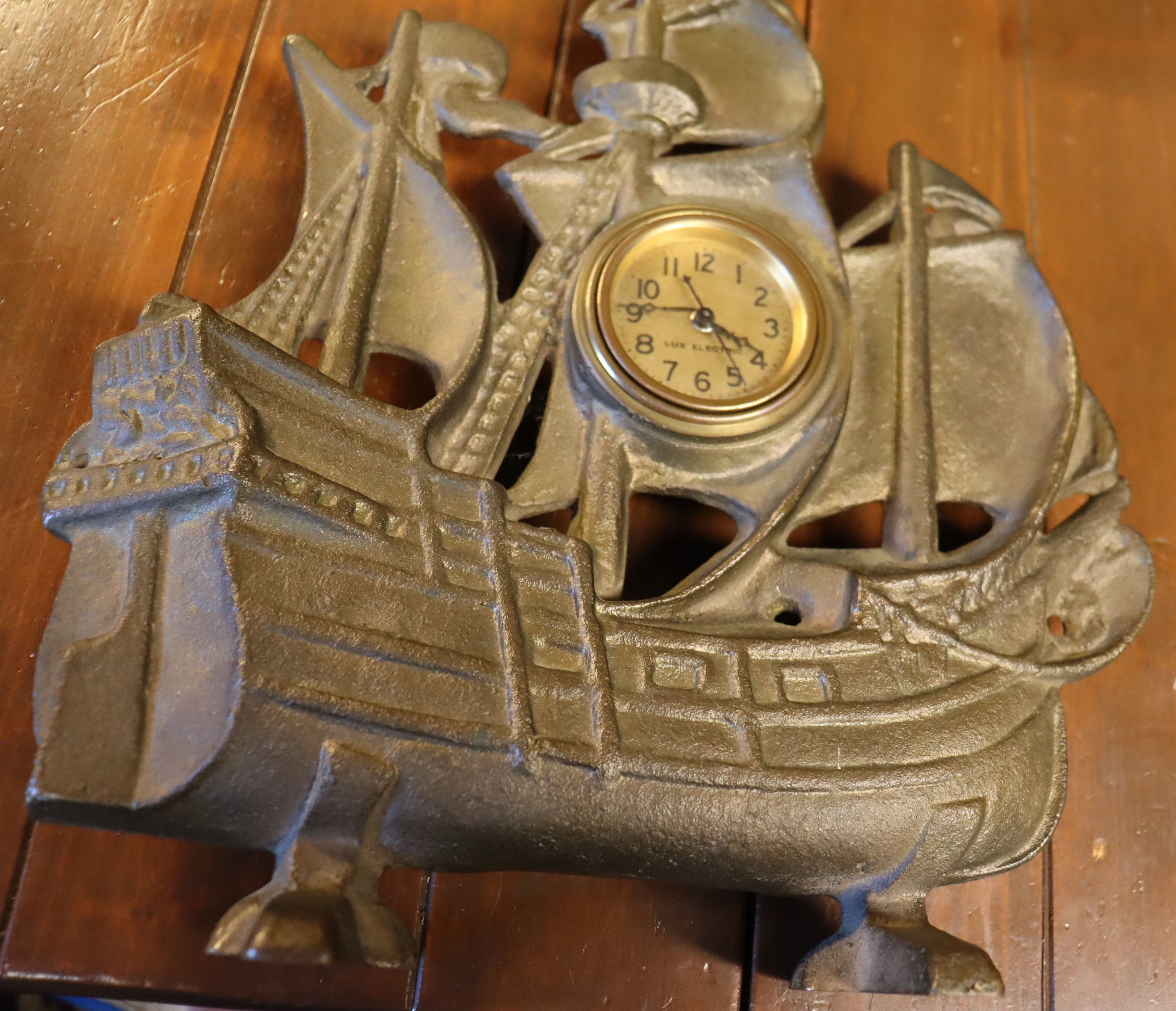 Vintage solid brass sailing ship with Lux electric clock.