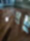 Master-level application of a high-performance protective coating on a Calgary hardwood floor, featuring superior optical clarity and depth.