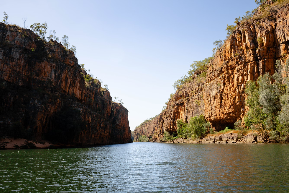 a-body-of-water-surrounded-by-mountains-and-trees