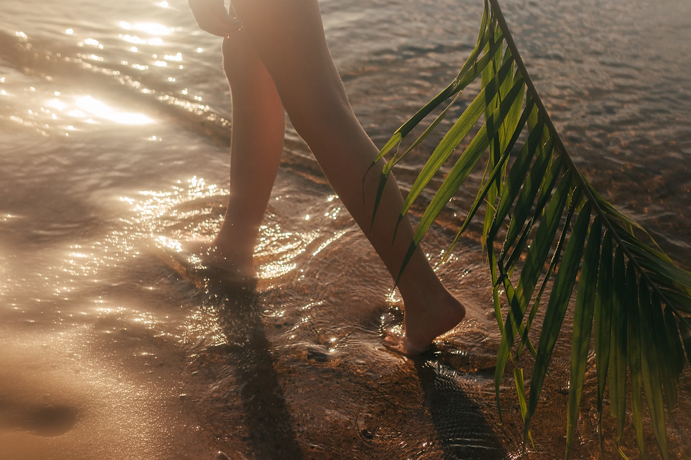 a-persons-legs-in-a-swimsuit-holding-a-green-tube