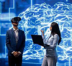 woman-with-laptop-explains-vr-technology-to-man-2026-03-19-02-07-08-utc.jpg
