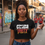 Thumbnail: The Community Is Not OK” Women’s Crop Top Tee