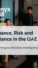 Senior executives reviewing governance and compliance frameworks in a boardroom setting, illustrating the shift from compliance reporting to decision intelligence in UAE organisations.