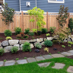rock-lined planting beds with stone pathways