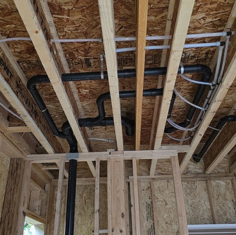 Plumbing lines installed in the ceiling of a new home construction