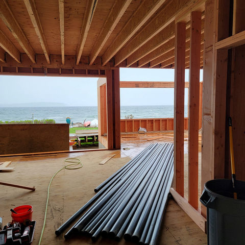 New home being built on the waterfront with plumbing pipes laid out on the floor by Shelco Plumbing in Snohomish country, Washington