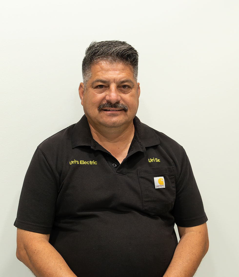 Portrait photo of a man wearing a black Uri's Electric polo shirt