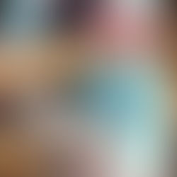 Child wearing a floral hat and "CUTE" shirt holds a lamb on her lap, sitting on a wooden bench. Warm, joyful setting with soft colors.