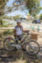 Woman with bicycle near community grant projects site