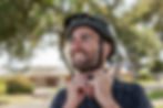 Smiling cyclist fastening helmet for Community Grant Projects