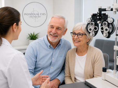 A friendly senior couple smiling during an eye examination with an optometrist.