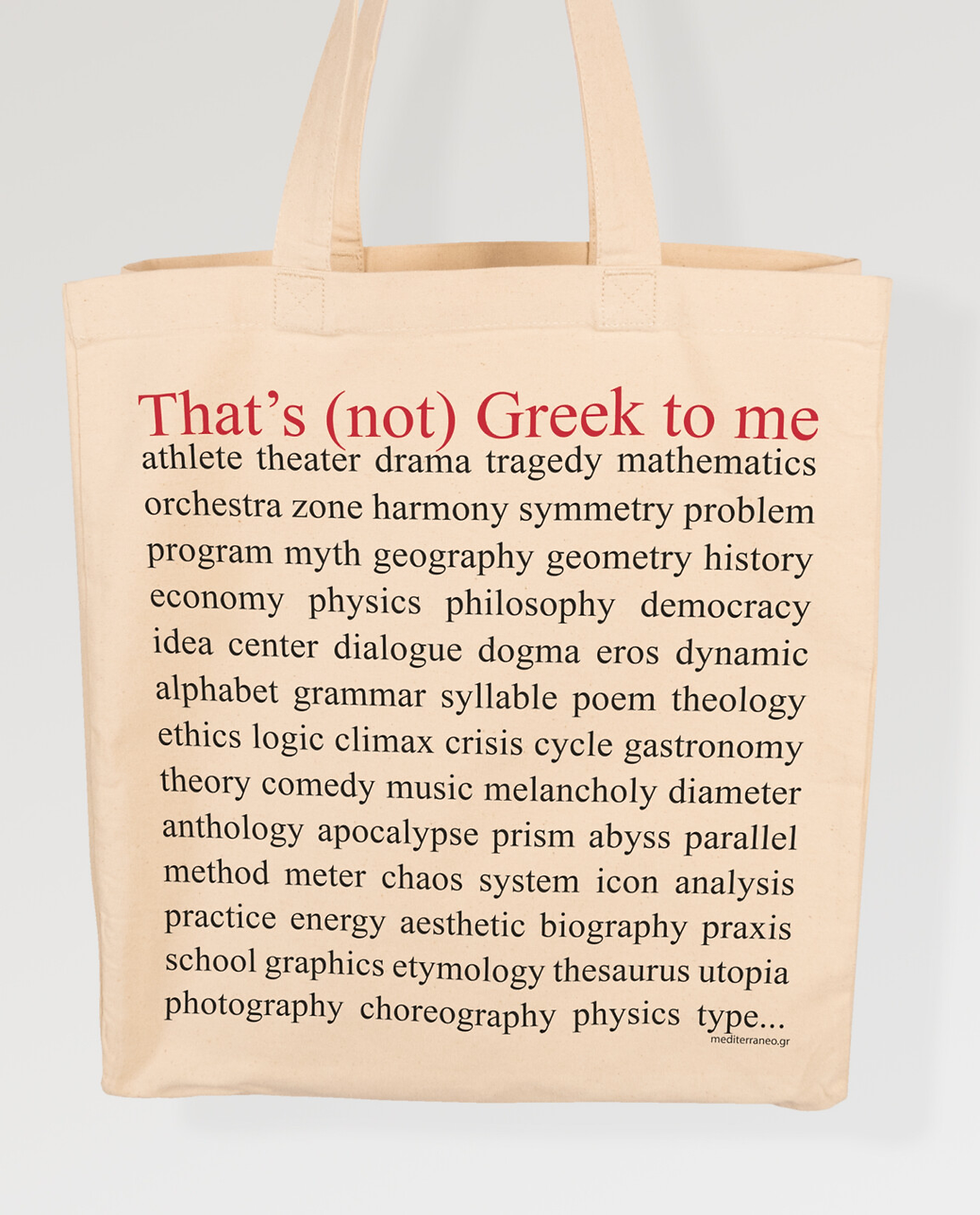 Beige tote bag with red and black text: "That's (not) Greek to me" followed by a list of words. Simple, minimal design.