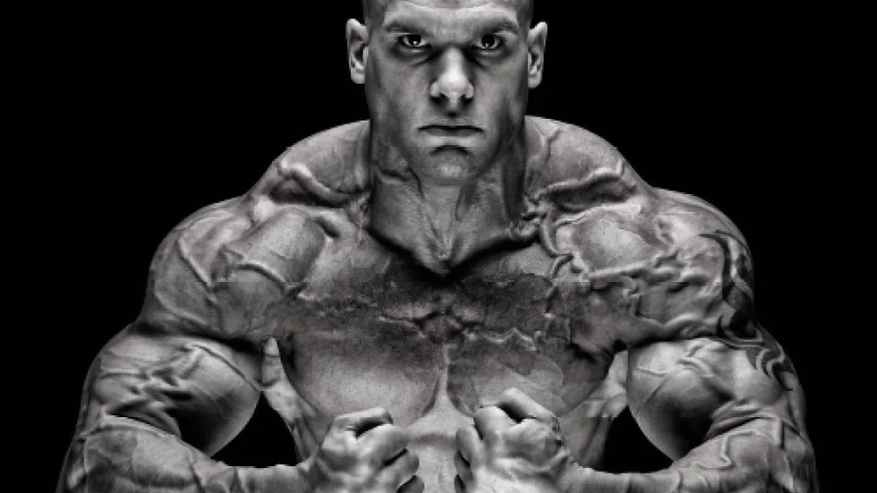 Muscular man with clenched fists in a powerful pose on a dark background. His veins are prominently visible, creating an intense and bold look.