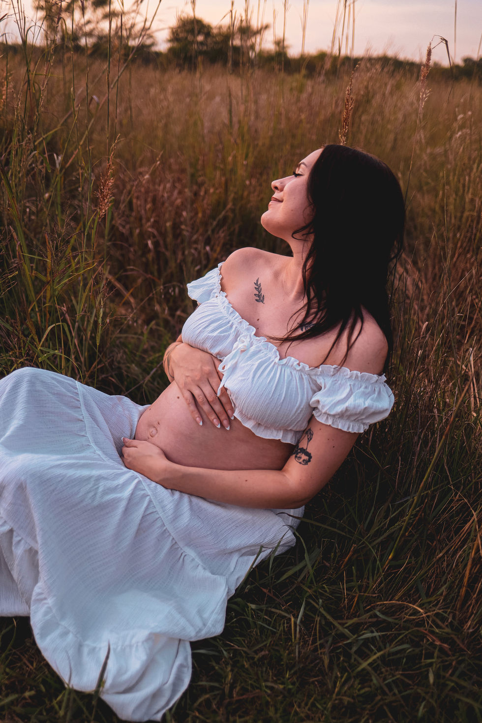 Wichita maternity couple embracing golden hour