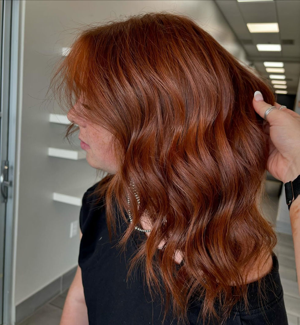Wavy copper red hair styled by a professional stylist