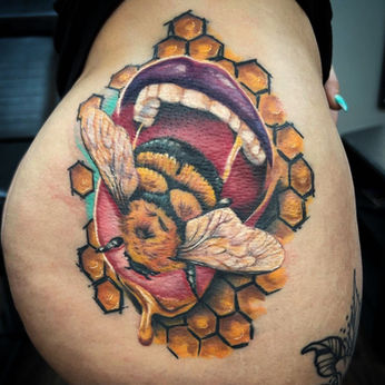 Tattoo of a honey bee in a mouth