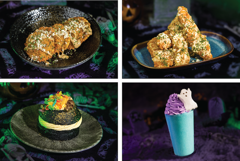 Four Halloween-themed dishes displayed: pasta in black bowl, fried chicken on blue plate, dark cake with colorful topping, and purple milkshake with ghost.
