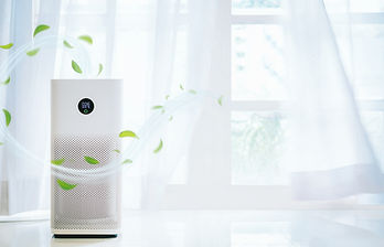 Air purifier in a cozy living room efficiently removing airborne contaminants.