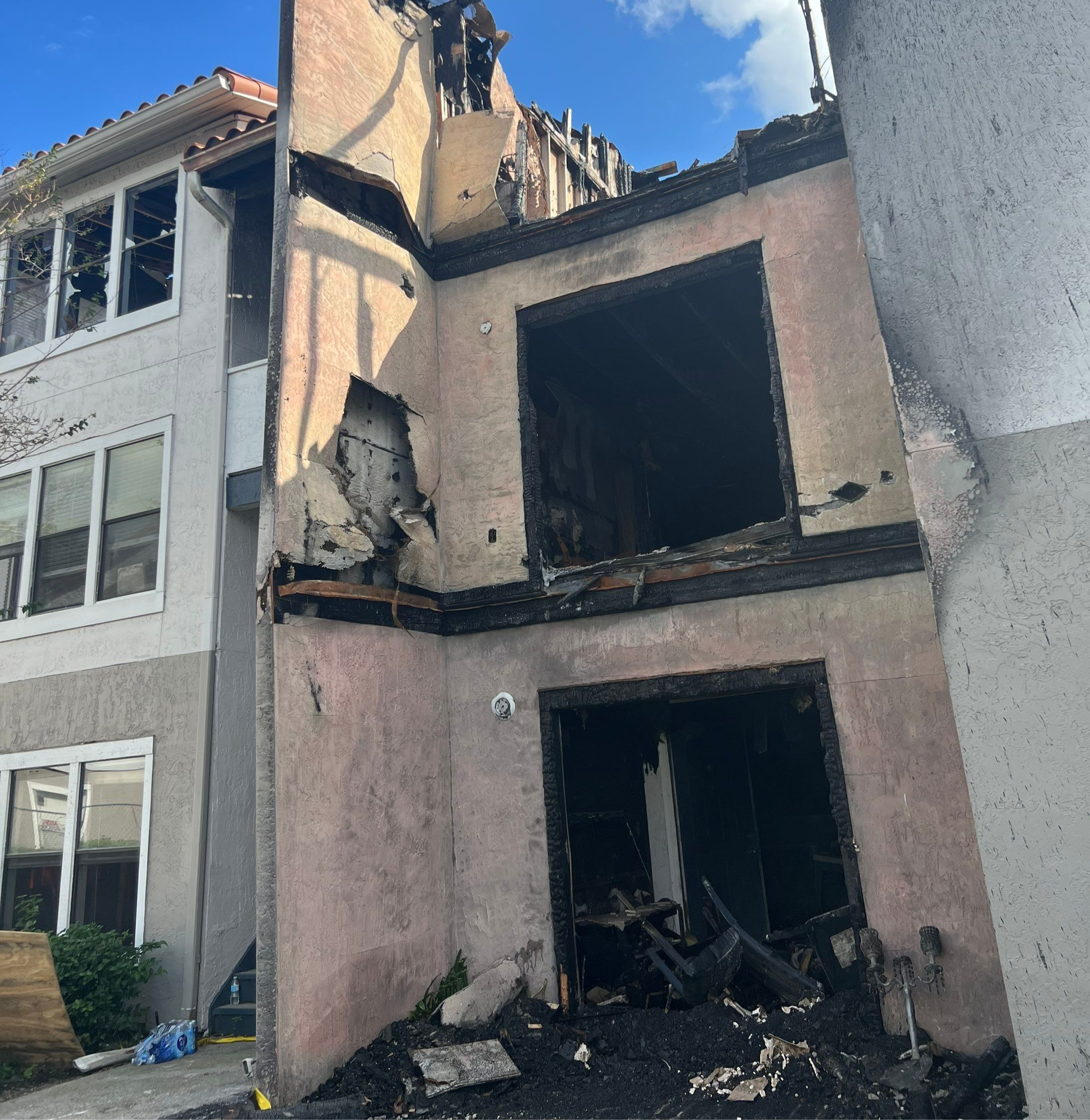Charred facade of an apartment building post-fire, highlighting the urgency of commercial fire damage recovery.