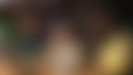 Educator mentoring elementary students during a learning session in a school library