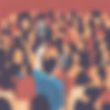 person speaking to a crowd with a microphone.jpg