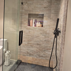 Frameless glass shower with matte black hardware in Los Angeles remodel project