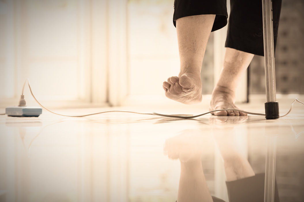 Electrical cord or socket cluttered on the floor,feet of senior woman stepping over obstac