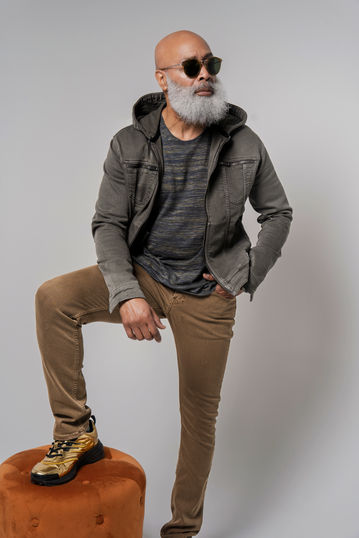 a man with a beard is wearing a jacket with a hood